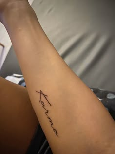 a woman's arm with the word faith written in cursive writing on it