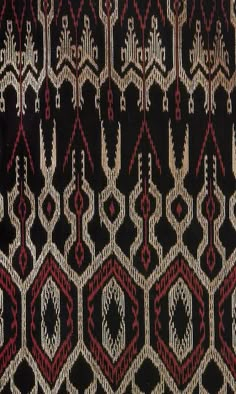 an old black and red rug with geometric designs