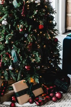 a christmas tree with presents under it