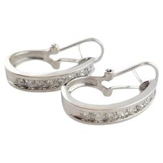 Vintage 14K White Gold Diamond Hoop Earrings This gorgeous set of hoops were crafted from 14K white gold and feature 16 sparkling round brilliant cut diamonds! Approximate total diamond weight: .72 cts Diamond color: I Diamond clarity: I1-I2 Size: 22.46mm X 14.2mm X 4.8mm Weight: 3.6 dwt/ 5.6 g Hallmark: SB 14K Very good condition, professionally polished. Will come packaged in a gift box or pouch (when possible) and will be shipped U.S. Priority Mail Insured. MM122623/17KCS Classic Hoop Earrings With Single Cut Diamonds, Formal Platinum Hoop Earrings With Single Cut Diamonds, Platinum Hallmarked Anniversary Earrings, Platinum Hallmarked Earrings For Anniversary, Luxury Diamond White Earrings With Channel Set, Luxury Diamond White Channel Set Earrings, Channel Set Cubic Zirconia Earrings Fine Jewelry, Classic Platinum Hoop Earrings With Single Cut Diamonds, Platinum Hoop Earrings With Single Cut Diamonds