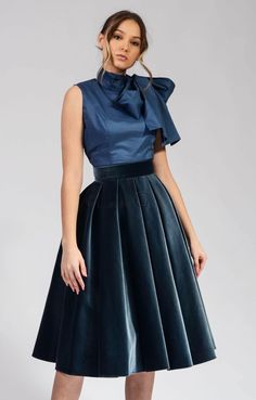 This gray velvet circle skirt is a must-have for any woman's wardrobe. It's made from 100% cotton, so it's both soft and elegant. The skirt has a high waist and a full circle skirt, which gives it a flattering and feminine look. The skirt is also lined, so it's comfortable to wear. This skirt is perfect for any occasion, from a night out to a special event. It can be dressed up or down, depending on the occasion. The gray color is versatile and can be paired with a variety of tops and accessorie Elegant Skirt-style Dress For Party Season, Elegant Dresses With Skirt Shape For Party Season, Elegant Party Season Dress With Skirt, Chic Velvet Party Skirt, Elegant Midi Skirt For Party Season, Party Dresses With Voluminous Midi Skirt, Voluminous Knee-length Evening Skirt, Elegant Holiday Cocktail Skirt, Knee-length Pleated Skirt For Party