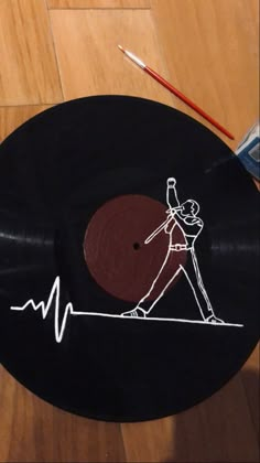 a record with a drawing of a man walking on a tightrope holding a baseball bat