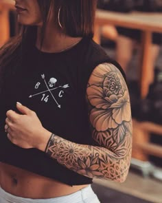 a woman with tattoos on her arms and shoulder