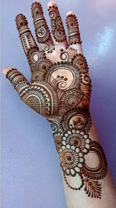 a hand with henna on it