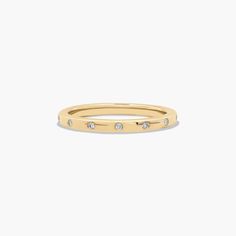 a gold ring with three diamonds on it