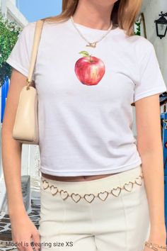 An apple a day keeps the doctor away 🍎 Get your fruity vitamins while wearing our trendy y2k baby tee shirt with a graphic red apple print. Style it with your low rise jeans or skirt and y2k sunglasses for the perfect vintage 2000s fit. Get yours now and wear it yourself or get a matching gift for your bestie in crime!  ------------------------------------------------------------------------------------------------------ Size guide Please take a moment to see the size chart, both in inches and