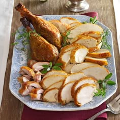 a plate with sliced turkey, potatoes and carrots