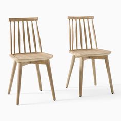 two wooden chairs sitting next to each other