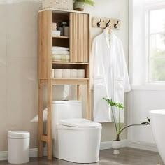 This over the toilet storage cabinet features a unique corrugated recessed panel with blister molding technology that adds texture and a sense of space, creating an extraordinary piece for your space. With white faux marble countertop with melamine veneer, delicate texture. With smooth curved edges and wide metal handles, it has both classic and modern charm.Maximize the size of your organization with our multifunctional cabinets. With adjustable shelves, sliding doors and a semi-open bottom com Over Toilet Storage Ideas, Toilet Storage Ideas, Over The Toilet Storage Cabinet, Faux Marble Countertop, Toilet Storage Cabinet, Over Toilet Storage, Over The Toilet Storage, Over The Toilet Cabinet, Bathroom Space Saver