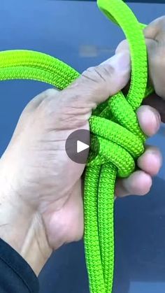 a person holding a green rope in their hand