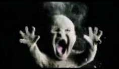 a person with their hands up and mouth wide open in front of the camera while screaming