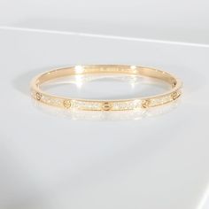 This is part of Chairish’s Fine Jewelry assortment.  Cartier Love Bracelet, Small Model, Paved 18K Yellow Gold 0.95 CTW   PRIMARY DETAILS   SKU: 137659   Listing Title: Cartier Love Bracelet, Small Model, Paved 18K Yellow Gold 0.95 CTW   Condition Description: Cartier's Love collection is the epitome of iconic, from the recognizable designs to the history behind the line-up. The collection started in 1969 with the bangle bracelet, which is engraved with a circular motif throughout to mimic the look of the bracelet's signature screw-lock mechanism.       Retails for 27300 USD. In excellent condition and recently polished. Comes with Box;Pouch;Original Receipt;   Brand: Cartier   Collection/Series: Love   Metal Type: Yellow Gold   Metal Purity: 18K   Pre-Owned Jewelry Condition: Excellent Luxury Gold Cartier Bracelet, Cartier Bracelet Panther, Gold Snake Bracelet Bangles, Elegant Yellow Gold Snake Bracelets, Cartier Love Collection, Luxury Elegant Snake-shaped Bracelets, Cartier Collection, Box Pouch, Love Lock