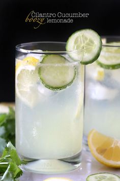 two glasses filled with lemonade and cucumber