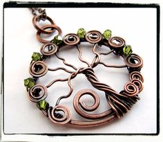 a tree of life pendant with green crystals