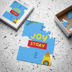 two pieces of puzzle sitting next to each other on a table with the word joy story printed on it