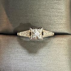 a diamond ring sitting on top of a cushion