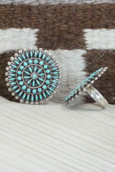 This Kingman turquoise and sterling silver necklace, earrings, bracelets, and rings set was made by Zuni silversmith Merlinda Chavez. The back of the necklace is signed D & M Chavez and Zuni.Necklace: 30"Length: 3 1/2"Width: 2 1/2"Earrings:Length: 1 3/4"Width: 1 3/4"Bracelets:Size: 5 3/4" (will fit up to a 7 1/8" wrist)Gap: 1 3/8"Length: 2 5/8"Rings:Size: 9.25 & 9.5Length: 1 3/4"Width: 1 3/4"Free shipping on all orders! We ship with USPS and always include tracking. All orders ship within a day Southwestern Style Blue Hallmarked Jewelry, Turquoise Round Jewelry With Sterling Silver Clasp, Turquoise Jewelry With Sterling Silver Clasp, Adjustable Southwestern Jewelry With Sterling Silver Clasp, Sterling Silver Hallmarked Turquoise Jewelry, Southwestern Sterling Silver Hallmarked Jewelry, Hallmarked Sterling Silver Turquoise Jewelry, Turquoise Jewelry Stamped 925, Southwestern Hallmarked Sterling Silver Jewelry