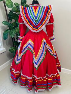 Step into the spotlight with our Beautiful Women's Jalisco Dress, a culturally inspired costume that embodies the spirit of Mexico. Handmade with love and attention to detail, this dress comes with 3 color satin ribbons in yellow, royal blue,  and green to add a pop of color to your ensemble.  Overview: Available in sizes S, M, and L, with bust lines ranging from 34-44" and skirt lengths from 24-34", this dress is a timeless piece for any celebration.  Delivery times: Please allow 2-3 weeks for Festival Dresses With Attached Cancan, Fitted Dress For Costume Party And Festivals, Traditional Fitted Dress With Attached Cancan, Multicolor Carnival Costume Dress, Multicolor Fiesta Dresses For Festivals, Multicolor Bohemian Costume Dress, Multicolor Dresses For Fiesta Festivals, Bohemian Multicolor Costume Dress, Fitted Folk Style Festival Dress