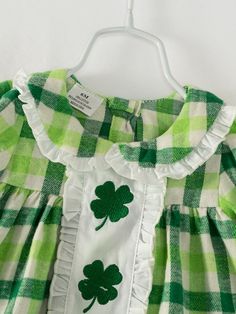 Dress your little leprechaun in this adorable St. Patrick's Day baby girl set! Made with soft, high-quality cotton, this green plaid outfit is perfect for celebrating in comfort. With a fun clover pattern, your little one will be the cutest shamrock at the party. (No pinching allowed!) 100% Cotton Care instructions: Cold wash, gentle cycle, hang dry or tumble dry low inside out, do not bleach, do not iron. Green Plaid Outfit, Clover Outfit, Clover Embroidery, Plaid Outfit, Girls Ruffle Dress, Clover Pattern, St Patrick's Day Outfit, Small Boutiques, Plaid Outfits