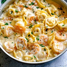 a skillet filled with pasta and shrimp