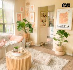 a living room filled with lots of furniture and plants on top of a white rug