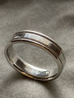 a wedding ring with two lines on the inside of it, sitting on a gray surface