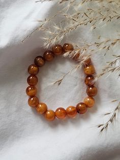 This elastic bracelet is made from unique amber colored beads. Luxury Amber Beaded Bracelets For Gift, Luxury Amber Beaded Bracelets For Gifting, Amber Beaded Bracelets With Polished Beads As Gift, Amber Beaded Bracelets As Gift, Amber Beaded Bracelets For Gift, Spiritual Amber Bracelets With Polished Beads, Amber Beaded Bracelets For Healing, Casual Brown Round Beads Bracelets, Brown Polished Beaded Bracelets As Gift