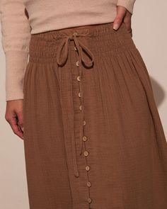 If you’re looking for effortless elegance and flair, the Serves Up Tie Waist Button Down Maxi Skirt is the perfect selection. This stunning maxi skirt effortlessly combines comfort and style, perfect for any season. Featuring a versatile drawstring tie waist, it flatters every figure while allowing for a customizable fit. The charming front button detailing adds a touch of sophistication, seamlessly blending casual and chic vibes. Runs large, consider sizing down Drawstring tie waist Front buttons Maxi length Unlined 100% Cotton Button Down Maxi Skirt, Chic Vibes, Swimwear Bottoms, Dresses By Length, Satin Slip, Wrap Sweater, Dress Gift, Effortless Elegance, Shop Sweatshirts