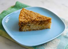 a piece of cake sitting on top of a blue plate next to a green napkin