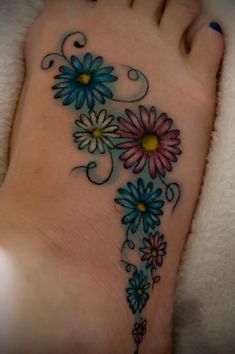 a woman's foot with flowers on it