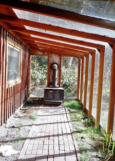 the inside of an old building with wooden beams and brick walkway leading up to it