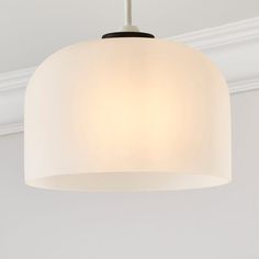 a white light fixture hanging from a ceiling