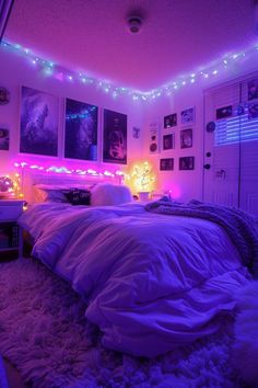 a bedroom with purple lights and pictures on the wall