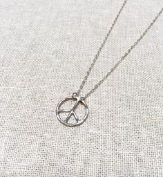 Add this dainty Peace Sign Necklace to your jewelry collection. Available in three fine metals: Sterling Silver, 14k Gold Fill and Rose Gold Fill. The diameter is measured for size. All White Sand Jewelry comes in a hand stamped gift box ready for gifting. NOTE: This listing is for ONE necklace only. PROCESSING TIME: Each piece is handcrafted and made-to-order, specifically for you. Although I do my very best to get orders out as quickly as possible, please allow up to five business days for you Everyday Metal Necklaces Nickel Free, Bohemian Stainless Steel Nickel Free Necklaces, Everyday Nickel-free Metal Necklaces, Everyday Metal Nickel-free Necklaces, Nickel-free Metal Necklaces For Everyday, Adjustable Metal Charm Necklaces For Anniversary, Adjustable Silver Brass Necklaces, Silver Brass Charm Necklace With Adjustable Chain, Adjustable Silver Brass Necklace