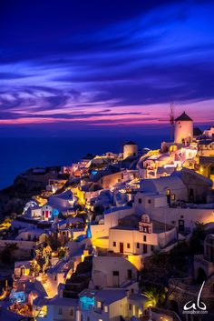 an image of a city that is lit up at night with lights on the buildings