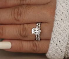 a close up of a person's hand with a ring on their finger and a diamond in the middle