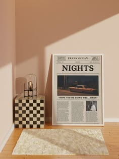 a newspaper sitting on top of a hard wood floor next to a lamp and checkered rug