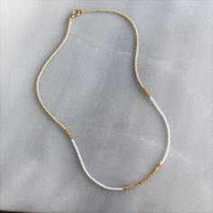 Our lithe necklace is handcrafted with a touch of gold in a minimalist style. •Seed beads in your choice of color combination •Hand strung in a modern pattern•14kt Gold-Filled beads & spring clasp •16 inches in length or 16 inches with a 2 inch extender Everyday Beaded 14k Gold-filled Necklaces, Everyday Beaded 14k Gold-filled Necklace, Everyday Beaded 14k Gold Filled Necklace, Everyday 14k Gold Filled Beaded Necklace, Everyday White Single Strand Necklace, Minimalist Single Strand Beaded Necklace, Everyday White Single Strand Beaded Necklace, Minimalist 14k Gold-filled Beaded Jewelry, Minimalist 14k Gold Filled Beaded Jewelry