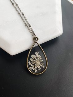 Real Pressed Flower Necklace 🖤 #pressedflowernecklace #pressedflowerjewelry #floralgifts #resinjewelrydiy #flowerresinnecklace #preservedflowergift #giftformom #realpressedflower #necklaceforher #minimalistjewelry #giftsfrometsy #handmadegiftguide #botanicalnecklace #realflowernecklace #resinjewelry #pressedflowerart #whiteaesthetic #brassnecklace #resindiy Brass Flower Pendant Necklace For Gift, Brass Flower Pendant Necklaces As Gifts, Brass Flower Pendant Necklace As Gift, Vintage Jewelry With Pressed Flowers For Gifts, Vintage Jewelry With Pressed Flowers Gift, Vintage Pressed Flowers Jewelry Gift, Memorial Flower Pendant Necklace With Birth Flower, Memorial Birth Flower Pendant Necklace, Vintage Flower Necklaces With Pressed Flowers