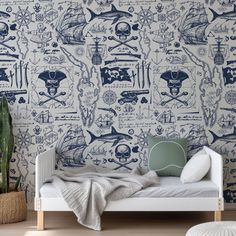 a room with a bed, plant and wallpaper that has pirate images on it