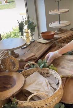 a woman is arranging baskets on a table