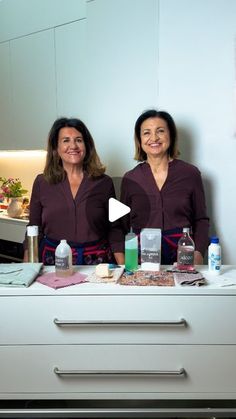 two women standing in front of a counter