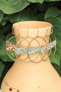 Add a vibrant touch to your outfit with these colorful beaded hoop earrings. Handmade with love, these hoops are crafted using golden brass and high quality seed beads in a delightful array of colors. The intricate beadwork adds a playful and eye-catching element to these earrings, making them a must-have for any jewelry lover. Lightweight and comfortable to wear, these hoops are perfect for adding a pop of color to your everyday style or dressing up for special occasions. They also make a wonde Nickel-free Metal Hoop Beaded Earrings, Brass Beaded Bracelets For Festivals, Multicolor Brass Beaded Earrings For Festival, Multicolor Beaded Brass Earrings, Multicolor Dangling Beaded Brass Earrings, Metal Hoop Earrings With Colorful Beads As Gift, Multicolor Metal Hoop Jewelry, Bohemian Hoop Beaded Earrings With Colorful Beads, Brass Beaded Earrings With Round Beads For Festival