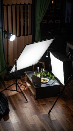 a table with food on it in front of a camera and light set up for a photo shoot