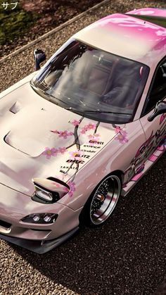 a pink car with flowers painted on it