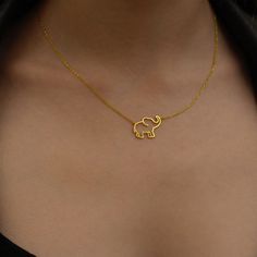 "Choose this beautiful elephant necklace for a cute reminder of mindful moments. Created by hand this gorgeous gold elephant necklace makes a perfect gift for the person who brings you joy. Wear this wealthy symbol necklace close to your heart to share with others how much you deeply care about their well being.  * Material: 14K Solid Gold (real solid gold, no gold-filled or no gold plated material), 925 Sterling Silver  * Choice of Gold Color: Yellow Gold, Rose Gold, White Gold  * Closure: Spring ring  * Chain style: Cable  * Style: Minimalist Thinking of gifting? Elevate your order with our Christmas Gift Wrap option! 🎁 Buy from here! https://www.etsy.com/listing/1580219719/ M O R E F R O M U S Mionza Jewels' pieces are handcrafted by 30 years of experienced craftsmen and made to order. Elephant Jewelry Necklace, African Necklaces, Gold Elephant Pendant, Elephant Necklace Gold, Beautiful Elephant, Mindful Moments, Elephant Jewelry, Gold Elephant, African Necklace