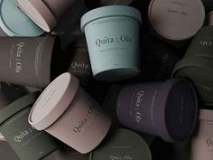 many different colored cups with the words quintaa on them in front of each other