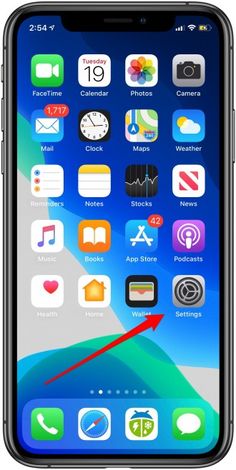 an iphone with the clock displayed on it's screen and red arrow pointing to the left