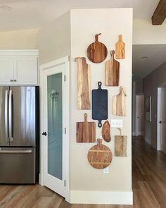 a kitchen with wooden cutting boards on the wall