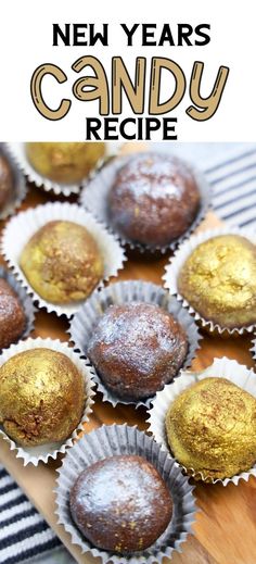 a wooden board topped with chocolates covered in powdered sugar and sprinkled with gold